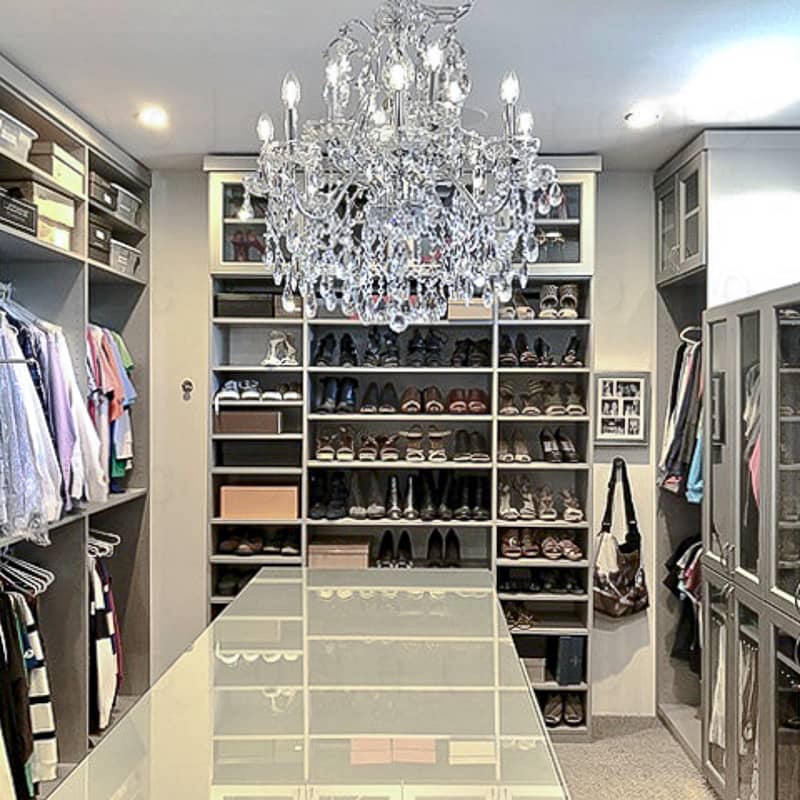 Grey walk in closet with grey island.