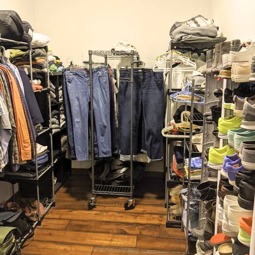 The before closet with clutter looking baskets and wire storage 