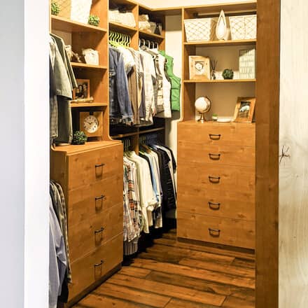 The now complete closet with drawers and clothing. Giving the closet a clean, orderly and organized storage.