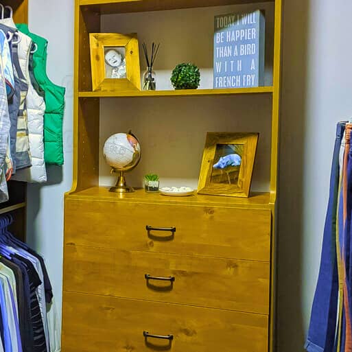 Brown closet with drawers and hanging