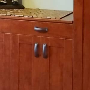 Medium warm brown pantry close up of the drawers and doors