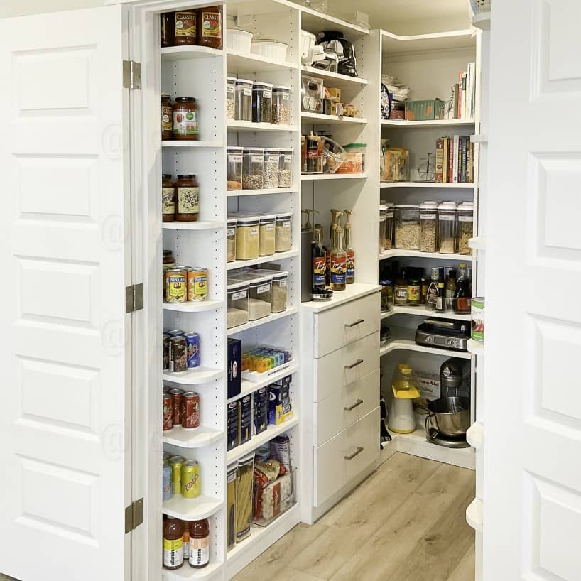 A Luxury White Closet with LED lighting, with medium hanging drawers, drawers, shelves.