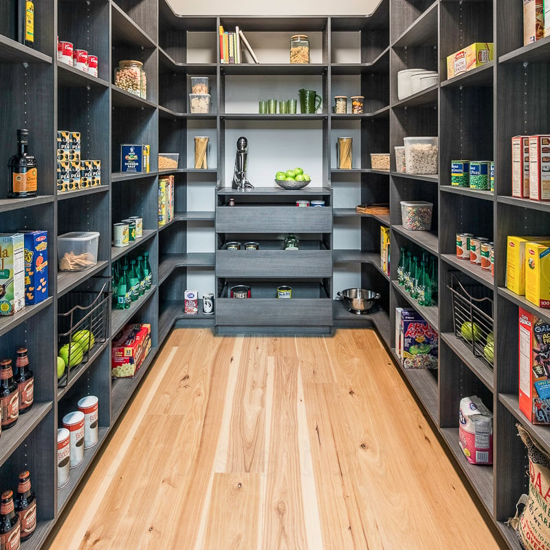 Walk in luxurious black pantry with shelves.