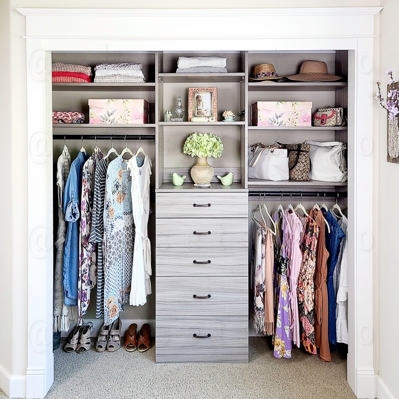 Reach in grey closet with drawers, long hang, medium hang and shelves.