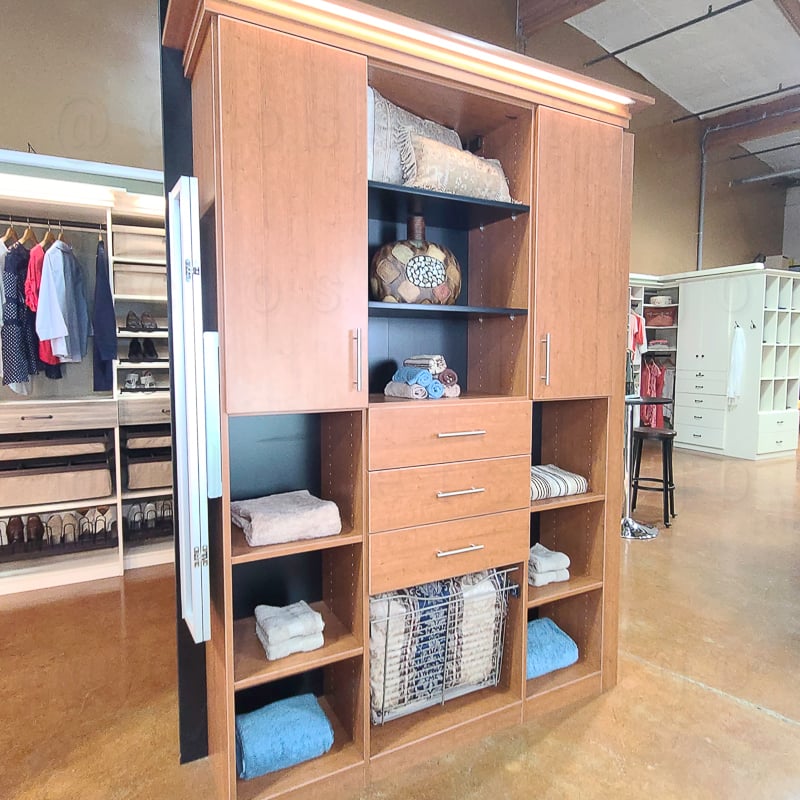 showroom reachin closet with cabinet drawers and shelves.