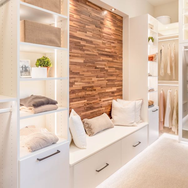 A Luxury White Closet with LED lighting, with medium hanging drawers, drawers, shelves.