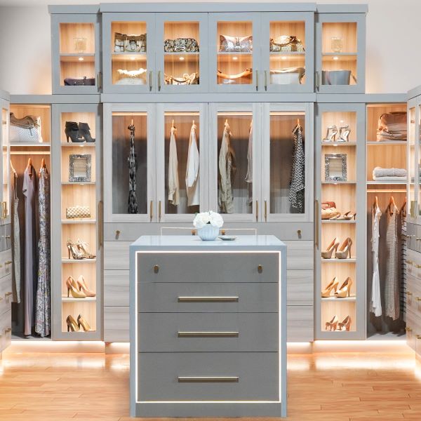 Showroom Luxury grey Walk in Closet with Led lighting, shelves, long hanging and medium hanging with glass doors. In addition an island in the center.