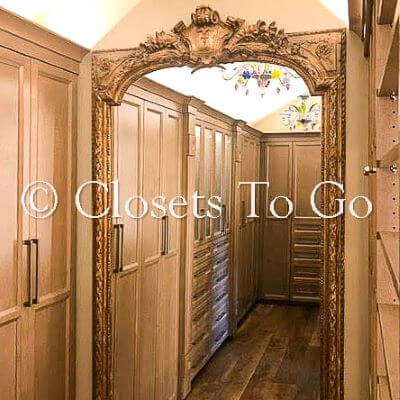 Brown walk in closet with mirror in the center