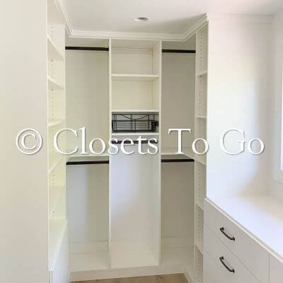 Walk in white pantry closest with natural lighting.