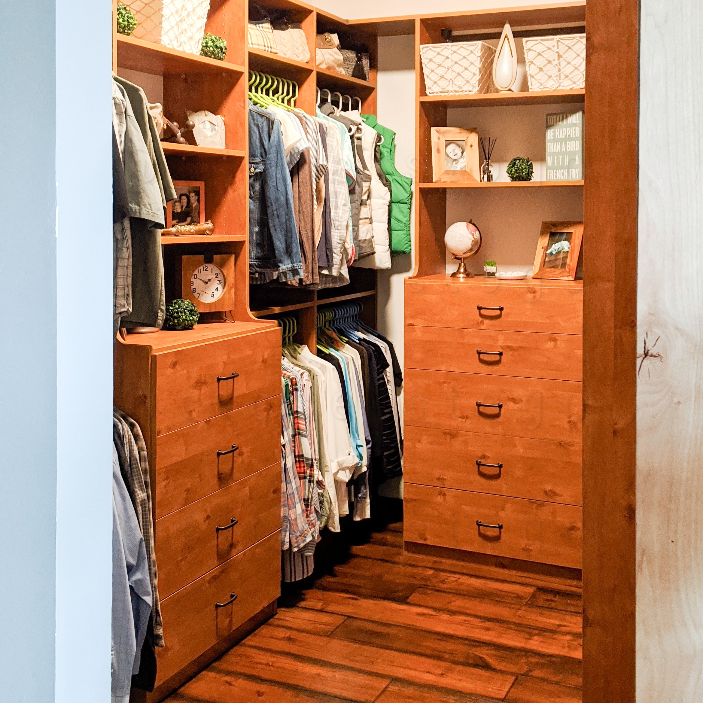 The now complete closet with drawers and clothing. Giving the closet a clean, orderly and organized storage.
