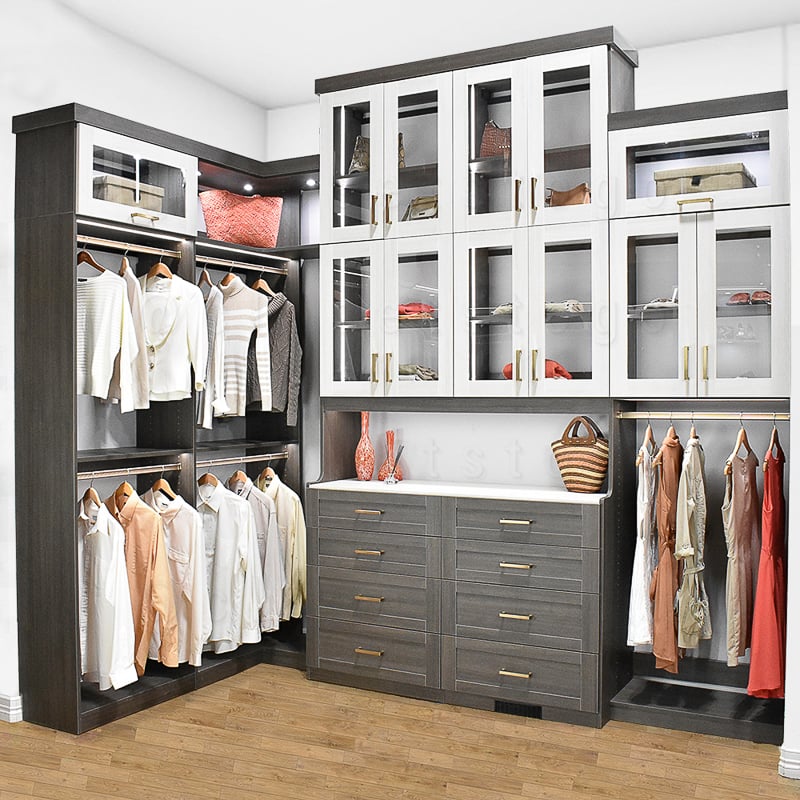 Walk in two toned grey and white closet with medium hang, glass doors and LED lights