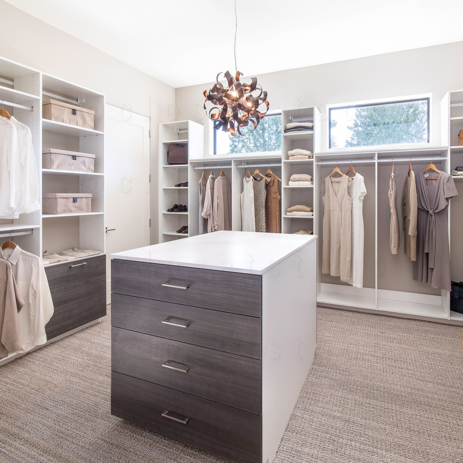 A walkin two toned closet with grey and white, with a center island and shelves, long hang and short hang